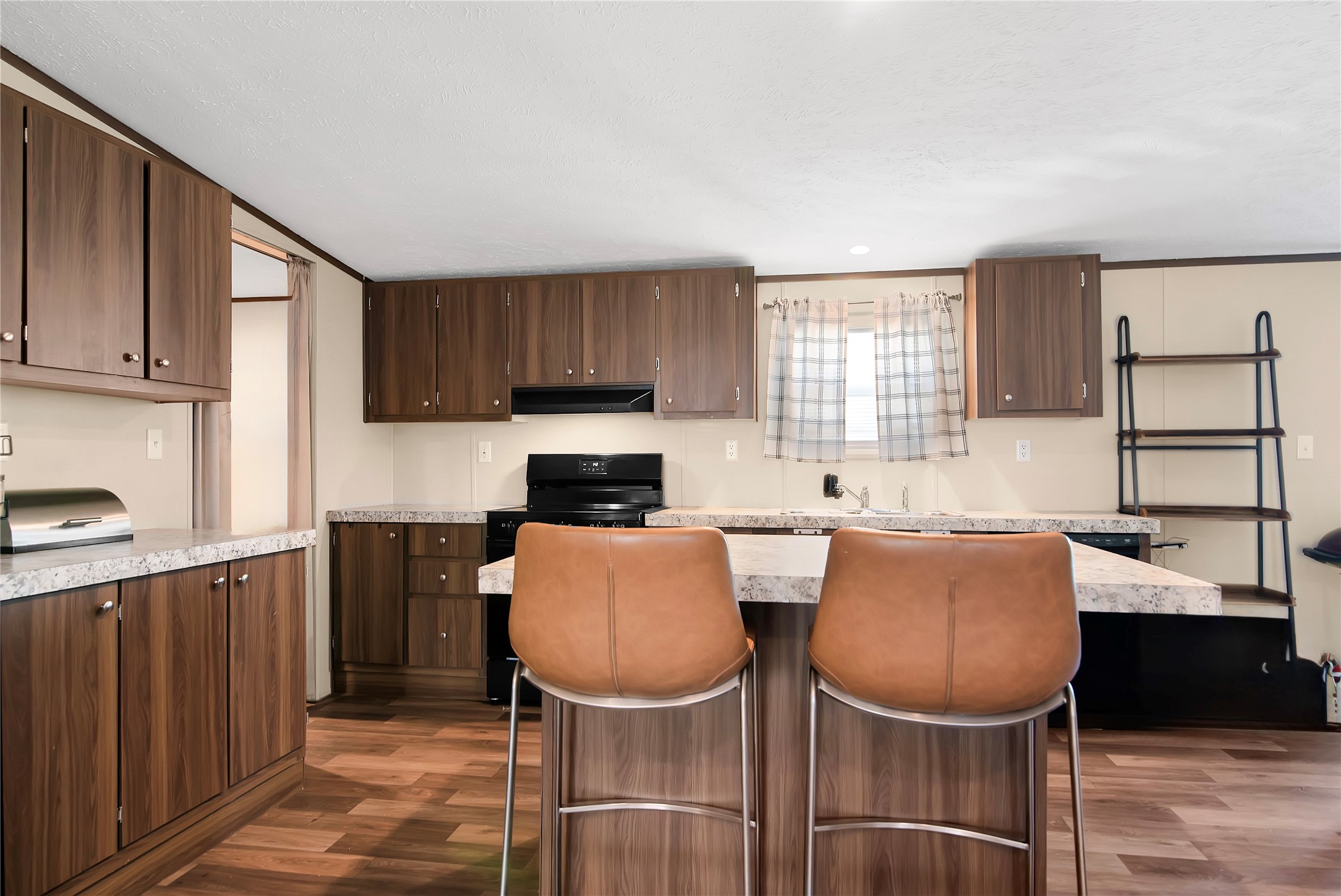 1007 Keswick Road Wilmer, TX 75172 - Photo 6 of 16 a kitchen with stainless steel appliances granite countertop a sink a stove a refrigerator cabinets and dining table