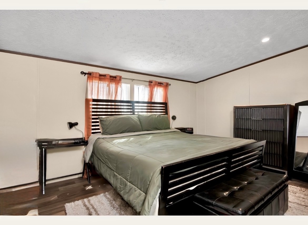 1007 Keswick Road Wilmer, TX 75172 - Photo 8 of 16 a bedroom with a bed and dresser