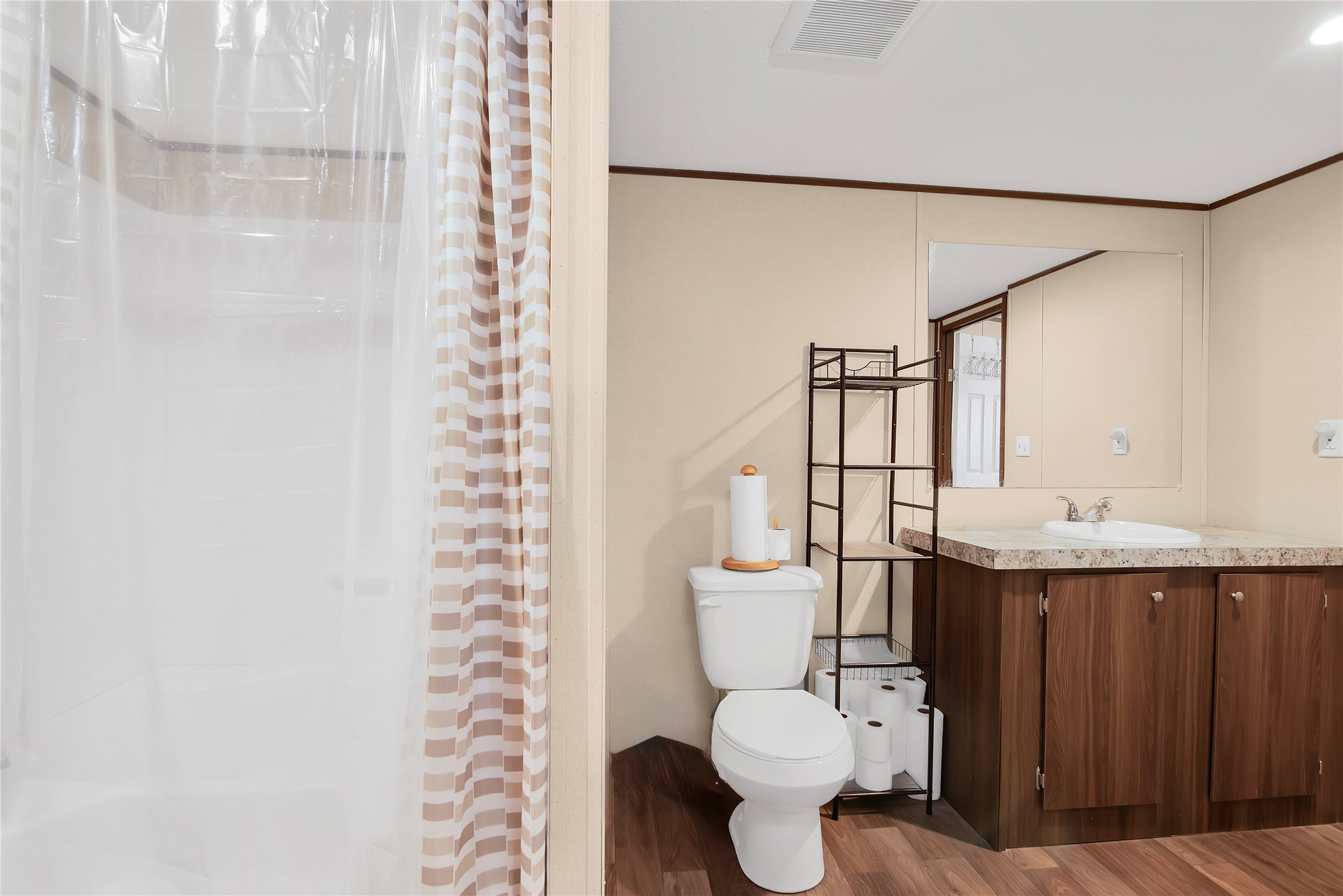 1007 Keswick Road Wilmer, TX 75172 - Photo 9 of 16 a white toilet sitting next to a bathroom sink