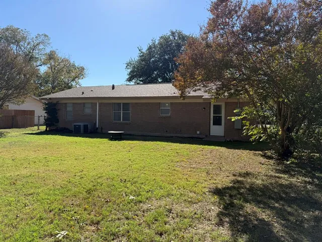 a front view of house with yard and trees
