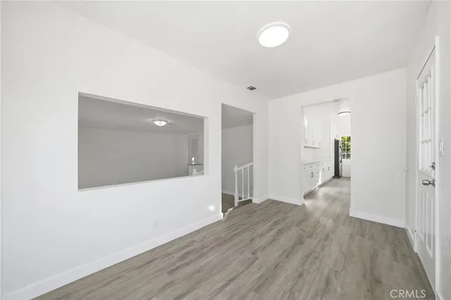 a view of hallway with wooden floor
