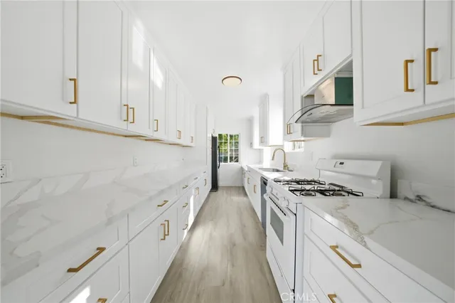 a kitchen with stainless steel appliances white cabinets and a stove