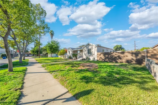 a view of yard with swimming pool and green space
