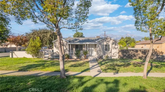 a view of a house with garden and sitting area