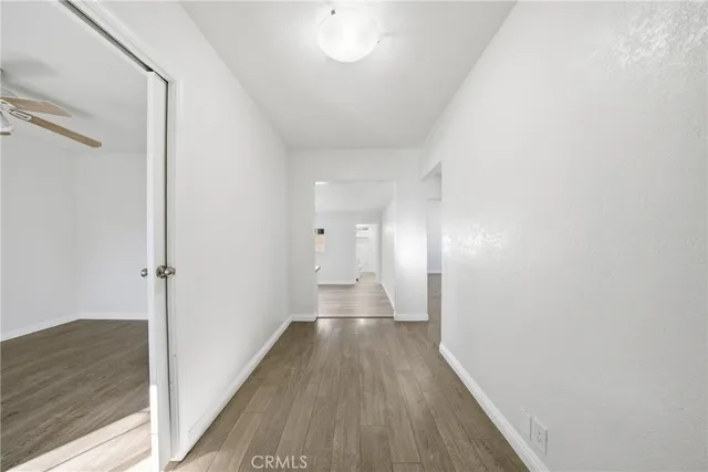 a view of hallway with wooden floor