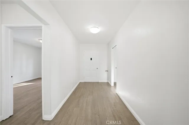 a view of a room with wooden floor