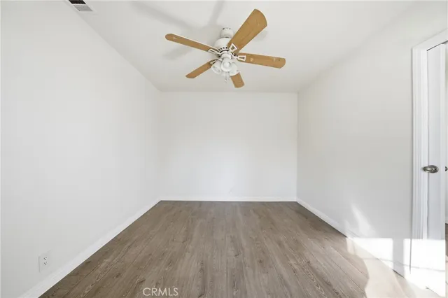 a view of a room with wooden floor and white walls
