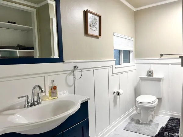 a bathroom with a sink toilet and vanity