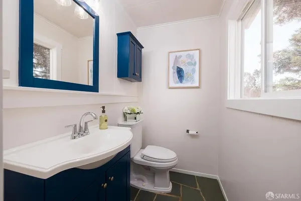 a bathroom with a sink mirror and toilet