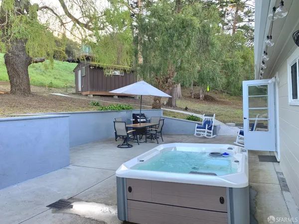 a table and chairs sitting in a backyard with a chair
