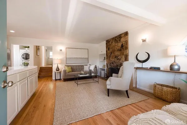 a living room with furniture and a large mirror