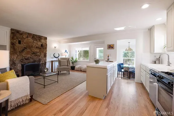 a living room with furniture and a fireplace