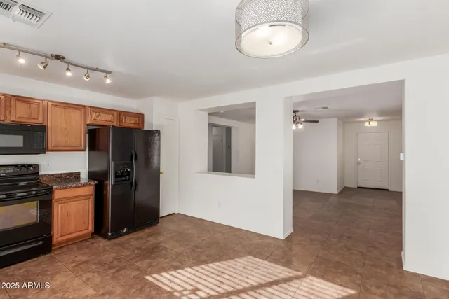 a view of a kitchen with a sink and refrigerator