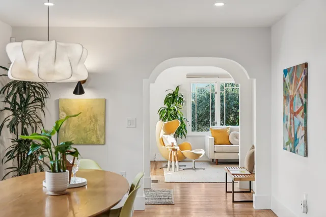 a dining room with furniture and wooden floor
