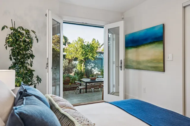 a living room with furniture and painting on the wall