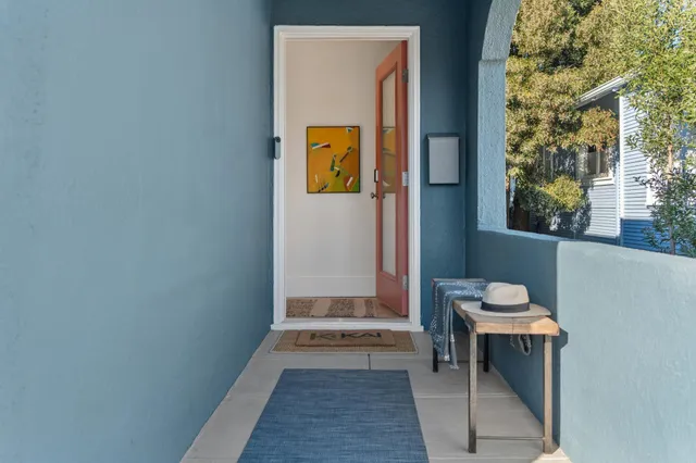 a living room with furniture a large window and a fireplace