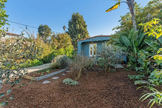 a view of a patio with table and chairs and potted plants