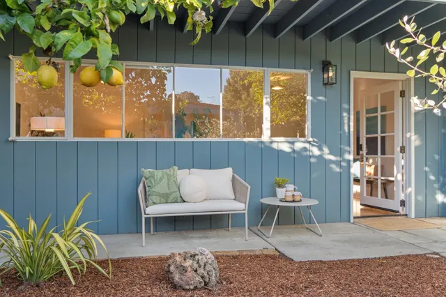 a front view of a house with outdoor seating