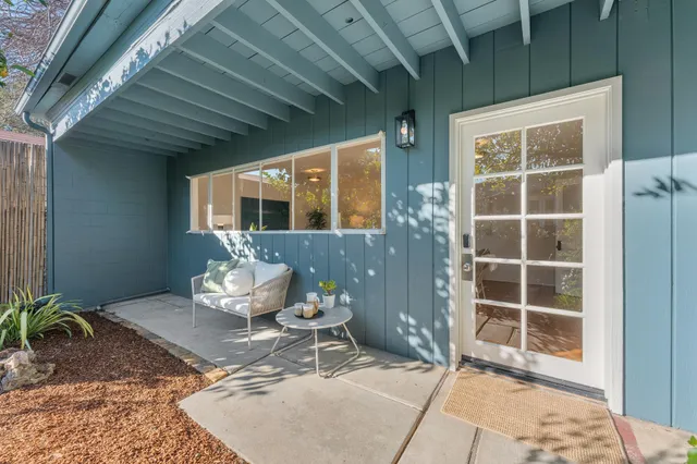 a backyard of a house with table and chairs