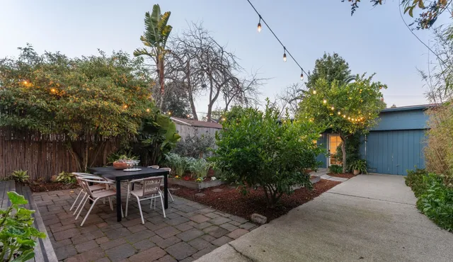 a view of a house with backyard and sitting area
