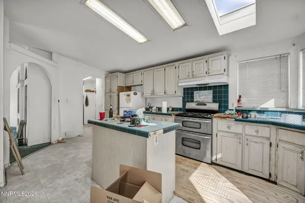 a kitchen with cabinets a sink and appliances