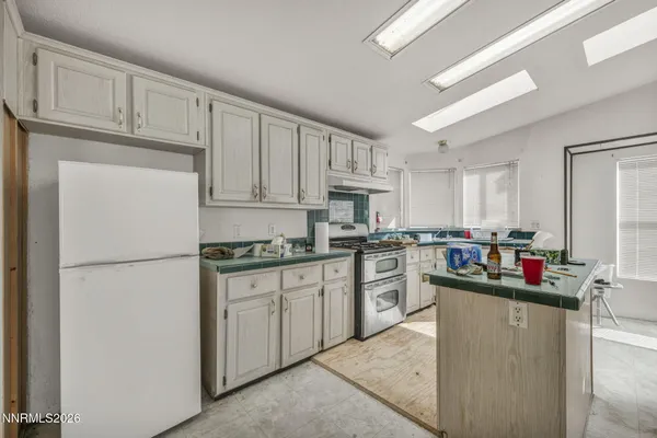 a kitchen with cabinets and white appliances