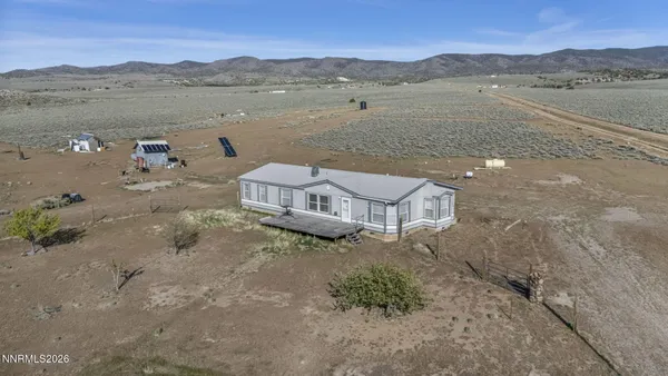 an aerial view of a house with a lake view