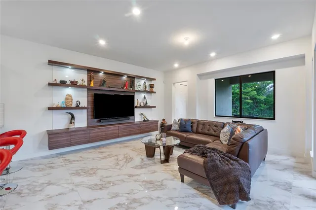 a large bedroom with a bed and a flat screen tv