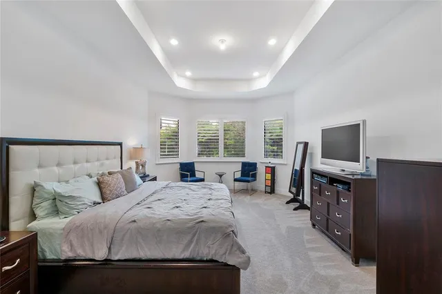 a bedroom with a bed wooden floor and window