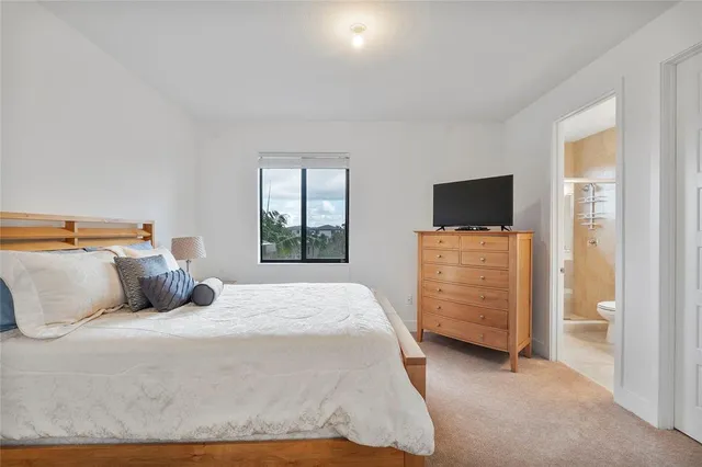 a bedroom with a bed and flat screen tv