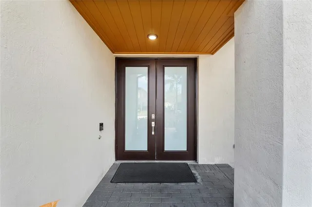a view of a livingroom with wooden floor and a flat screen tv