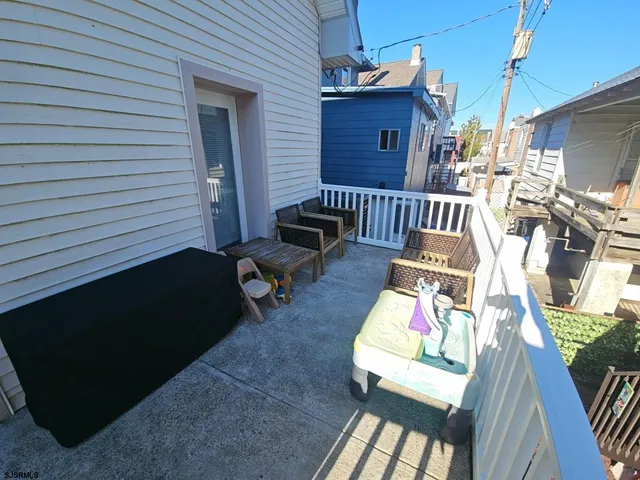 a view of a deck with wooden floor and furniture