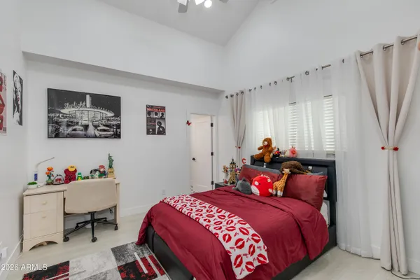 a bedroom with a bed and a desk