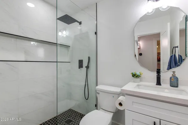 a bathroom with a sink toilet and shower