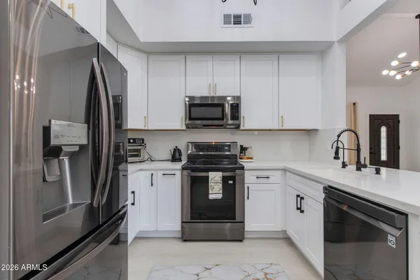 a kitchen with a stove sink and refrigerator