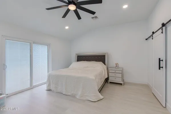 a bedroom with a bed and window