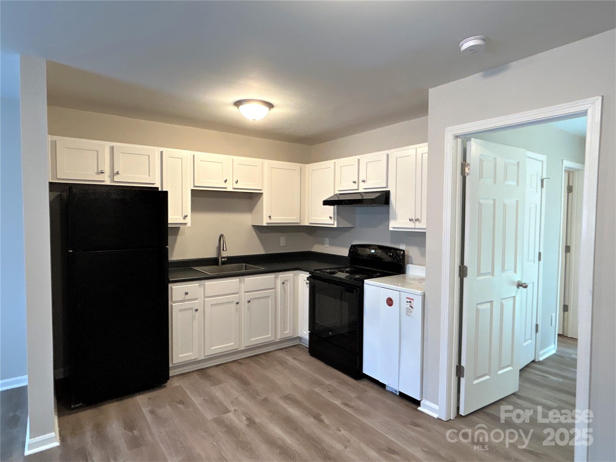 1850 Lowell Bethesda Road, Unit 6 Gastonia, NC 28056 - Photo 12 of 15 a kitchen with granite countertop white cabinets and refrigerator