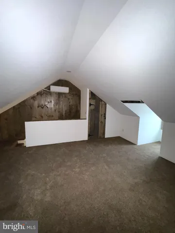 a view of a couches and a table in room