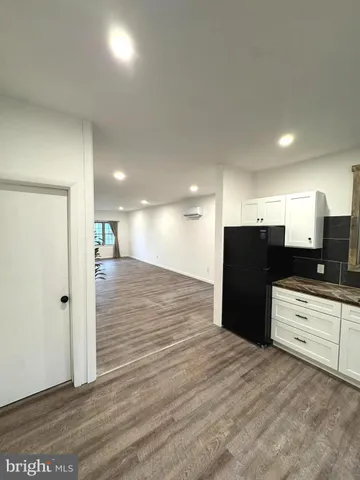 a view of kitchen with refrigerator and window
