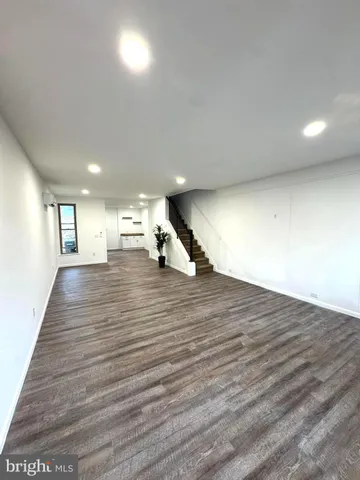 a view of a room with wooden floor