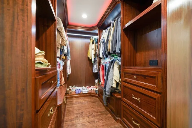 a view of walk in closet with clothes