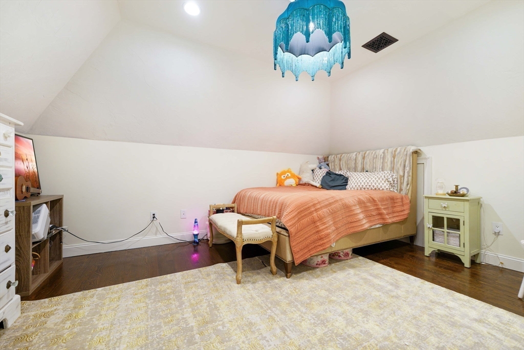 50 Elm Street Plympton, MA 02367 - Photo 31 of 40 a bedroom with a bed and a chandelier