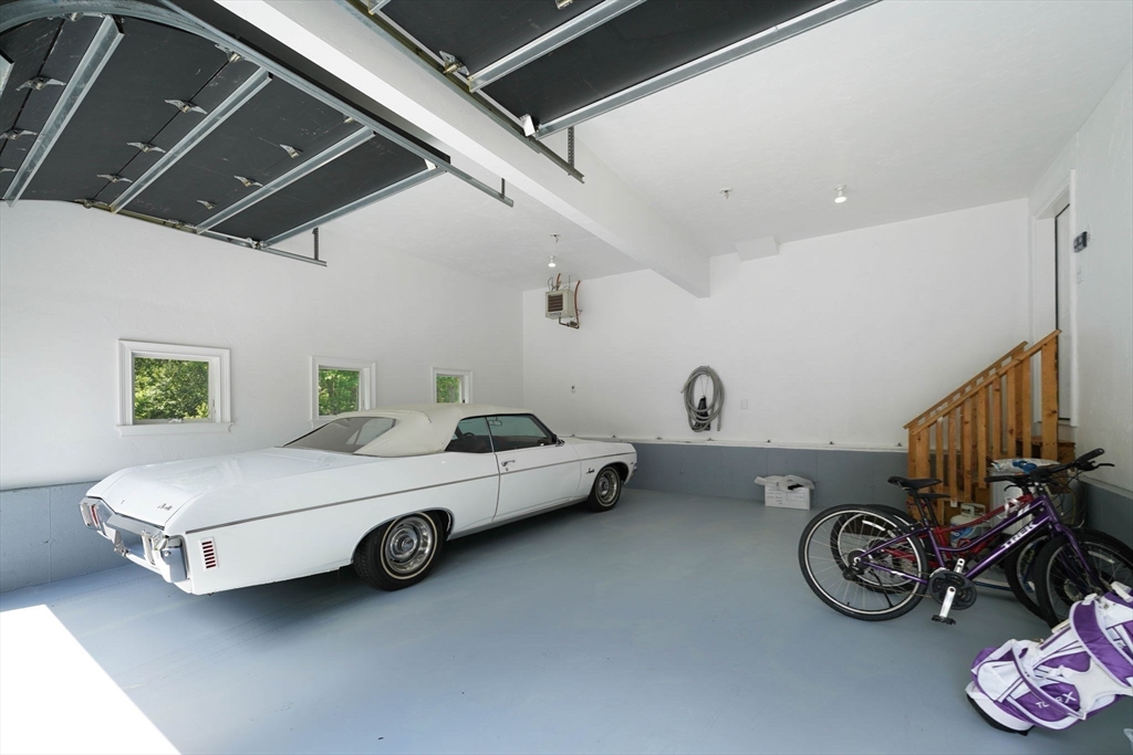 50 Elm Street Plympton, MA 02367 - Photo 36 of 40 a car and bike parked in a garage
