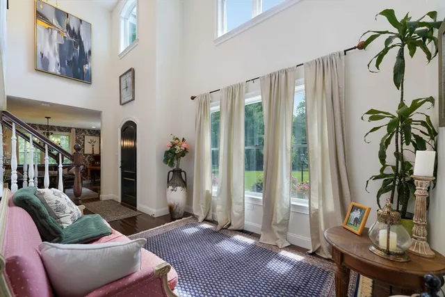 a living room with furniture lamp and window