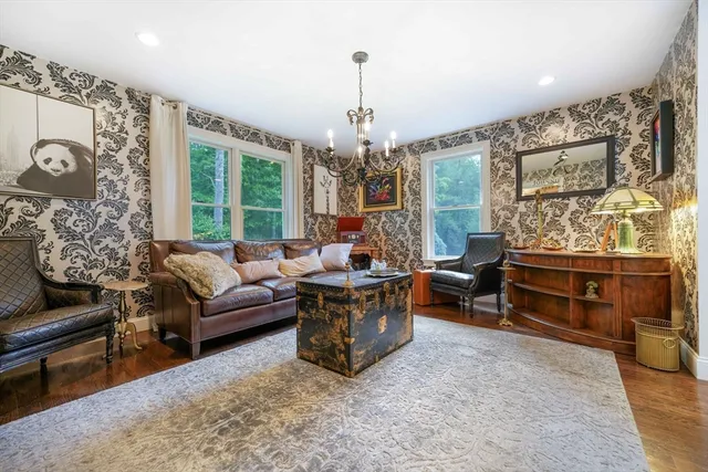 a living room with furniture and a chandelier