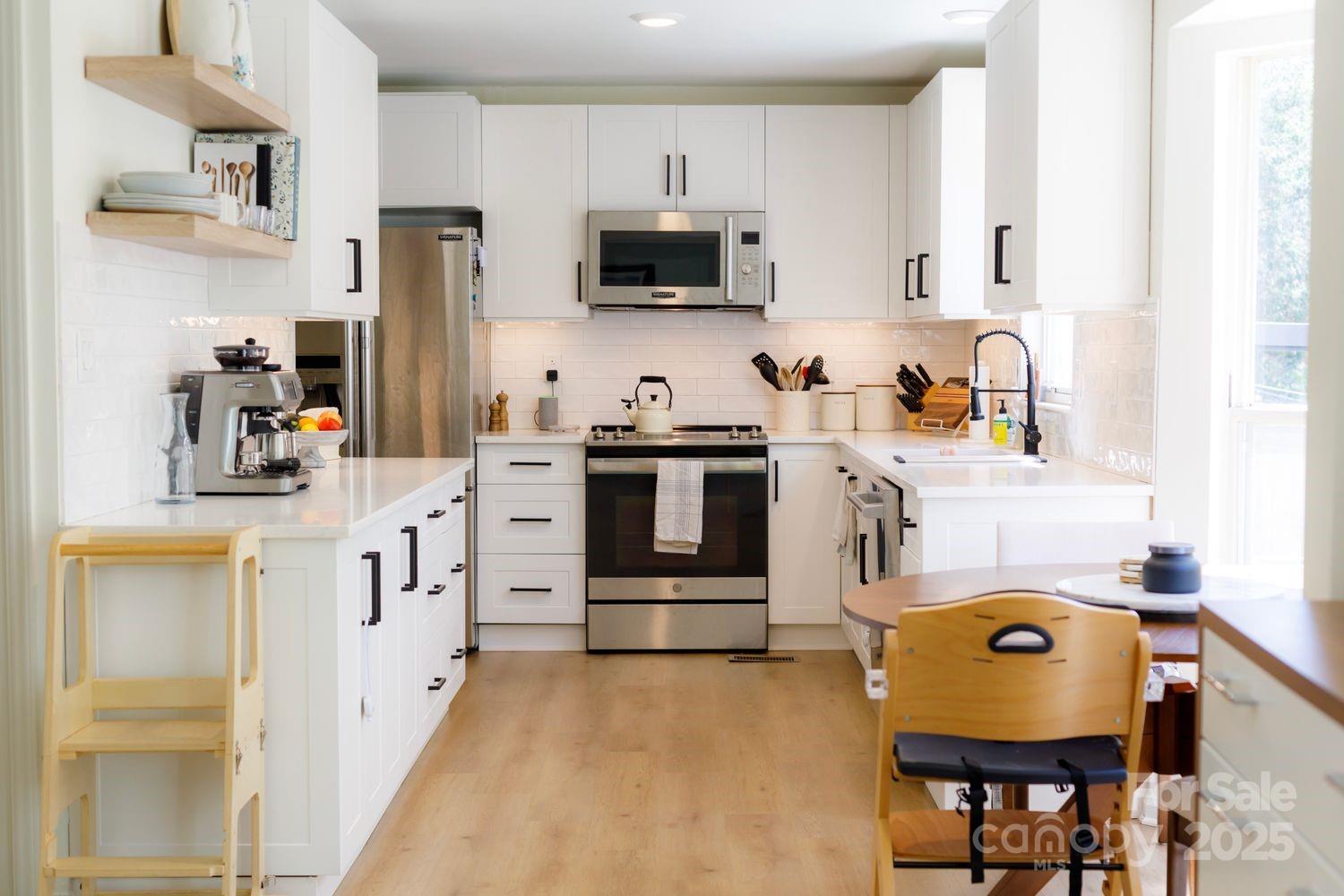 6718 Rollingridge Drive Charlotte, NC 28211 - Photo 2 of 6 a kitchen with stainless steel appliances a stove a sink cabinets and a refrigerator