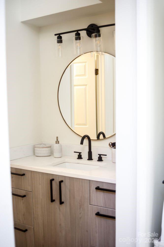 6718 Rollingridge Drive Charlotte, NC 28211 - Photo 3 of 6 a bathroom with a sink and a mirror