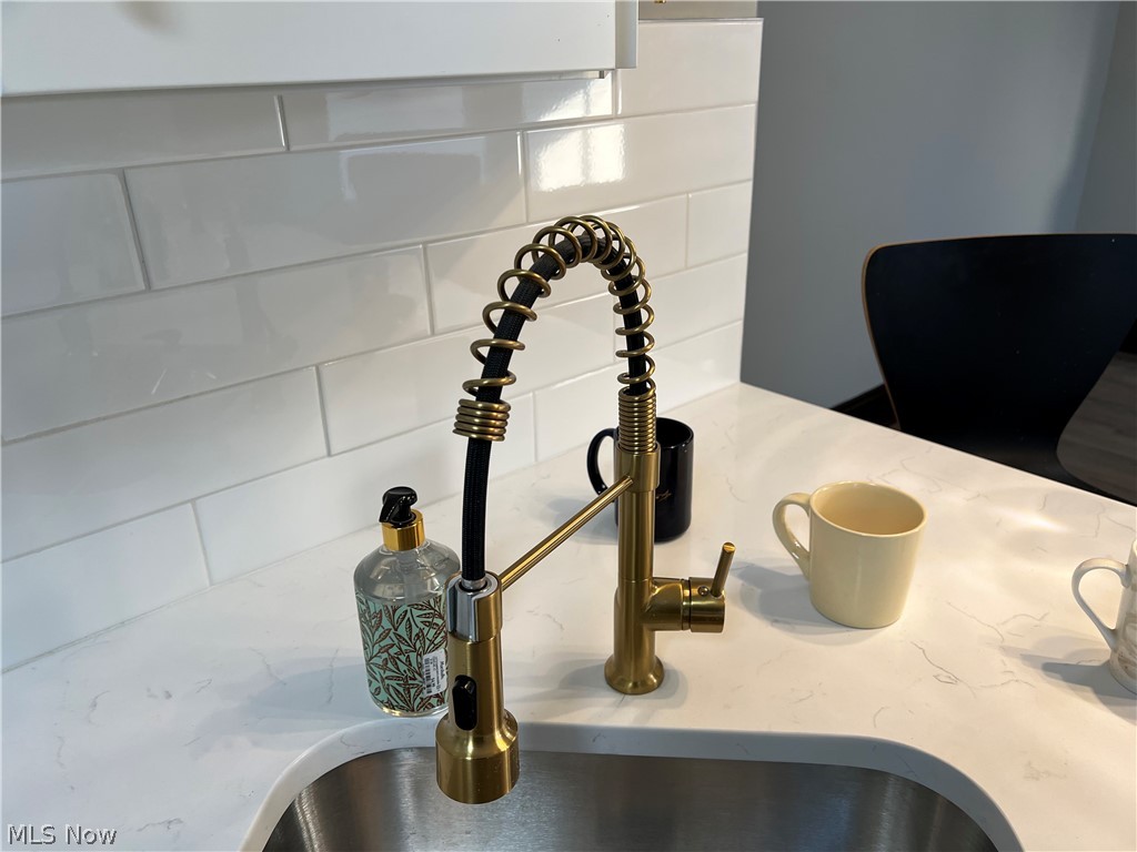 4523 Maplecrest Avenue Parma, OH 44134 - Photo 13 of 31 Room details featuring sink and tasteful backsplash