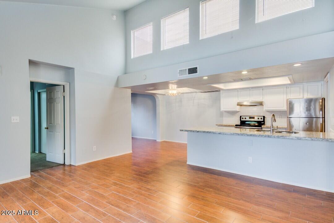 6900 East Gold Dust Avenue, Unit 149 Paradise Valley, AZ 85253 - Photo 12 of 34 a kitchen with stainless steel appliances granite countertop a sink and cabinets