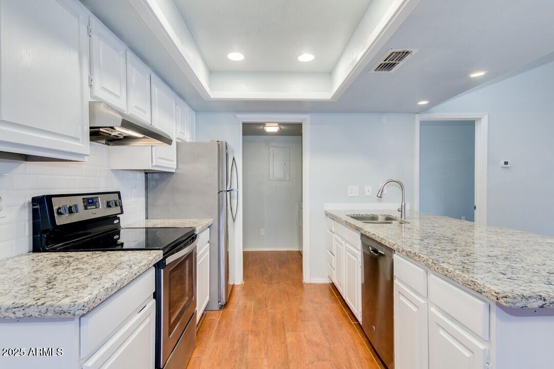 6900 East Gold Dust Avenue, Unit 149 Paradise Valley, AZ 85253 - Photo 16 of 34 a kitchen with stainless steel appliances granite countertop a sink stove and refrigerator